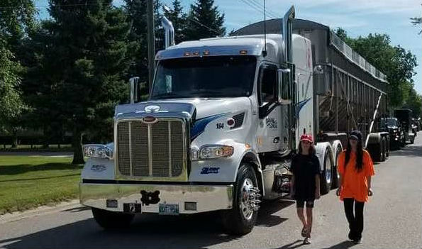 Two ladies standing near truck